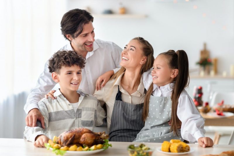 happy-family-with-parents-and-kids-posing-together-in-kitchen-preparing-meal-for-christmas-or.jpg